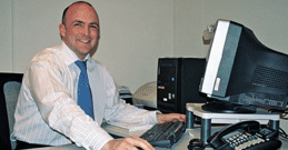 Man wearing tie at computer